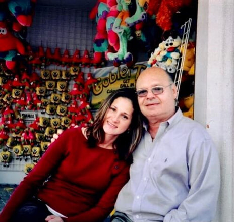 Joel Grossman (type 2 diabetic) inventor of Vial Safe with arm around daughter Stacy Caine and posing for photo at a carnival