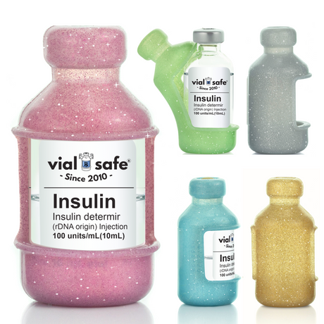 A collection of Vial Safe glitter insulin vial protector cases in various colors including green, pink, silver, blue, and gold, designed to fit most 10mL insulin vials.